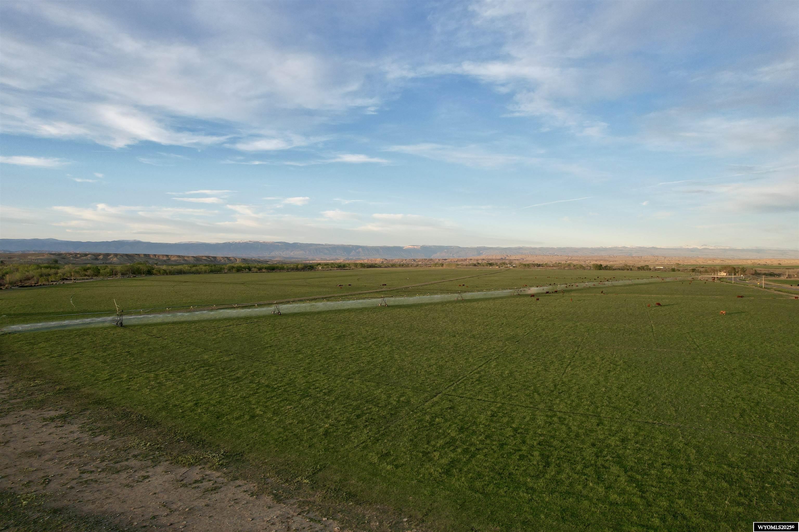 Located in Big Horn County, Wyoming, this 288+/- acre property offers a productive agricultural opportunity with valuable highway frontage. Of the total acreage, approximately 178 acres are pivot irrigated, supporting a wide range of potential uses including crop production and livestock operations. There is year around live water for easy livestock watering.  The land features mostly flat to gently rolling terrain, with an incredible building spot on the bluff above Dorsey Creek, the farm ground off to the west and Dorsey Creek below.  Access to the property is direct from a paved highway or also from the gravel county road, offering convenient ingress and egress for equipment, deliveries, and potential future development.  Electricity and rural water tap are on the property, which adds to the property’s development flexibility. Given its size, irrigation capability, and location, this property could be used for row crops, hay production, cattle grazing, or as an investment holding with potential for future homesite development.   Part of a larger parcel pending final survey
