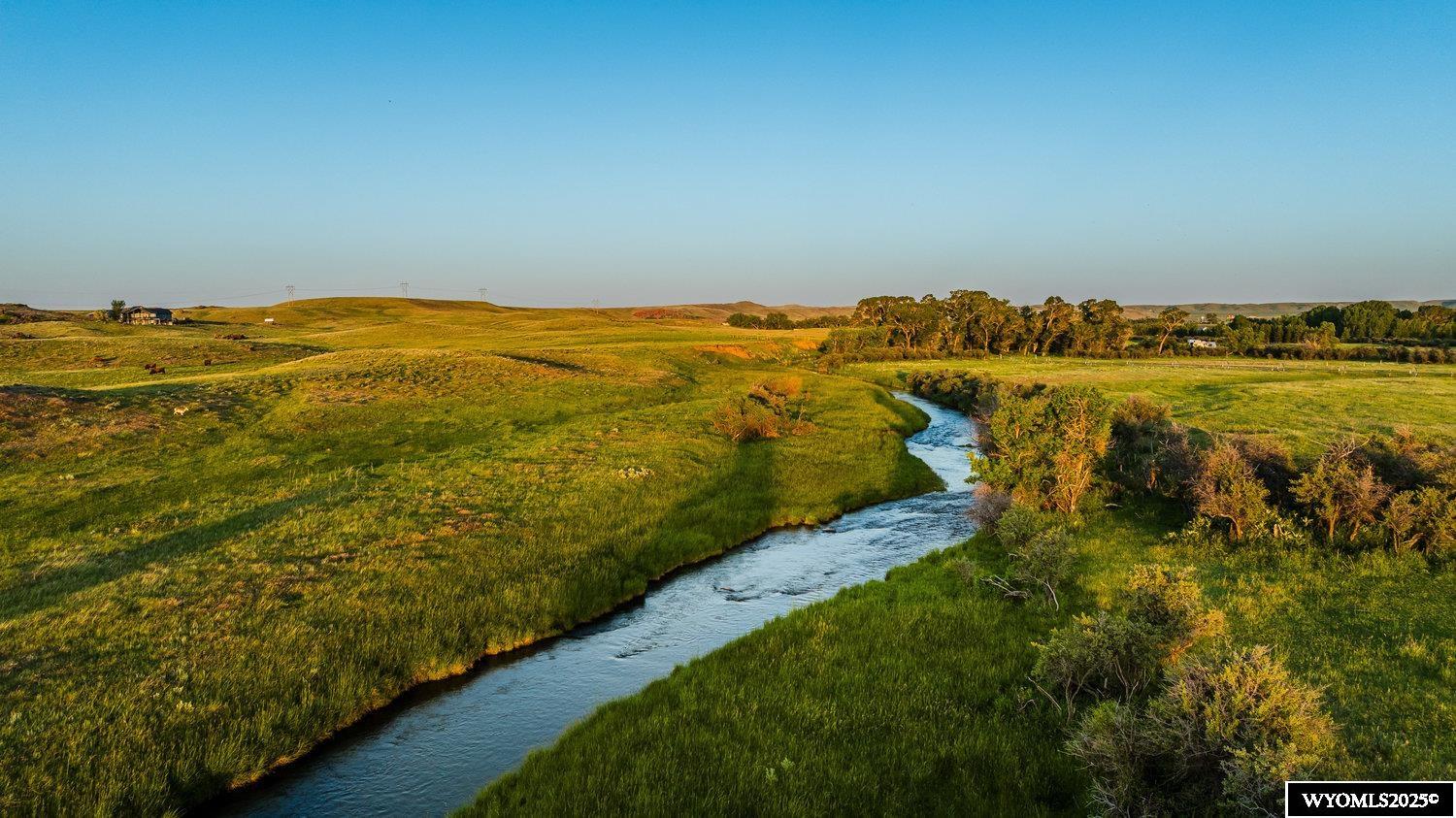 Minutes from Downtown Buffalo, Wyoming, this 225 +/- acre property has come to market with 1.5 miles of Rock Creek meandering through this productive and well-watered agricultural property.    This investment/development/homestead property is an excellent fly fishery under the backdrop of the scenic Big Horn Mountain Range.   Brown, Rainbow, and Brook trout reside within the banks of this gorgeous spring-fed tributary called Rock Creek.   Buffalo is one of the most scenic and historic towns in Wyoming, with a population of just under 5,000 residents.    Located off the east slope of the Big Horn Mountains at an elevation of 4,500 feet, with an incredible mountain views to the west rising to over 13,000 feet, which when combined make Buffalo well known as the Green side of the Big Horns, offering a plethora of outdoor activities including but not limited to fly fishing, hiking, mountain biking, horse back riding, packtirp’s, and is home to abundant large game, upland bird, water fowl populations.   When you are not enjoying these activities, you can add Cross Country and Alpine Skiing to your weekly bucket list, only minutes away!  Bordering I-25 and I-90, this is a developer’s dream.   Positioned in a manner you do not see the interstate traffic, yet get the magnificent views of the Big Horns, this investment/development/homestead property comes with territorial water rights, excellent hay production, and Rock Creek meandering 1.5 miles through the center of this property.   Feel free to review our video, pictures, and mapping of this very unique offering, and please reach out to preview this property at your earliest convenience!
