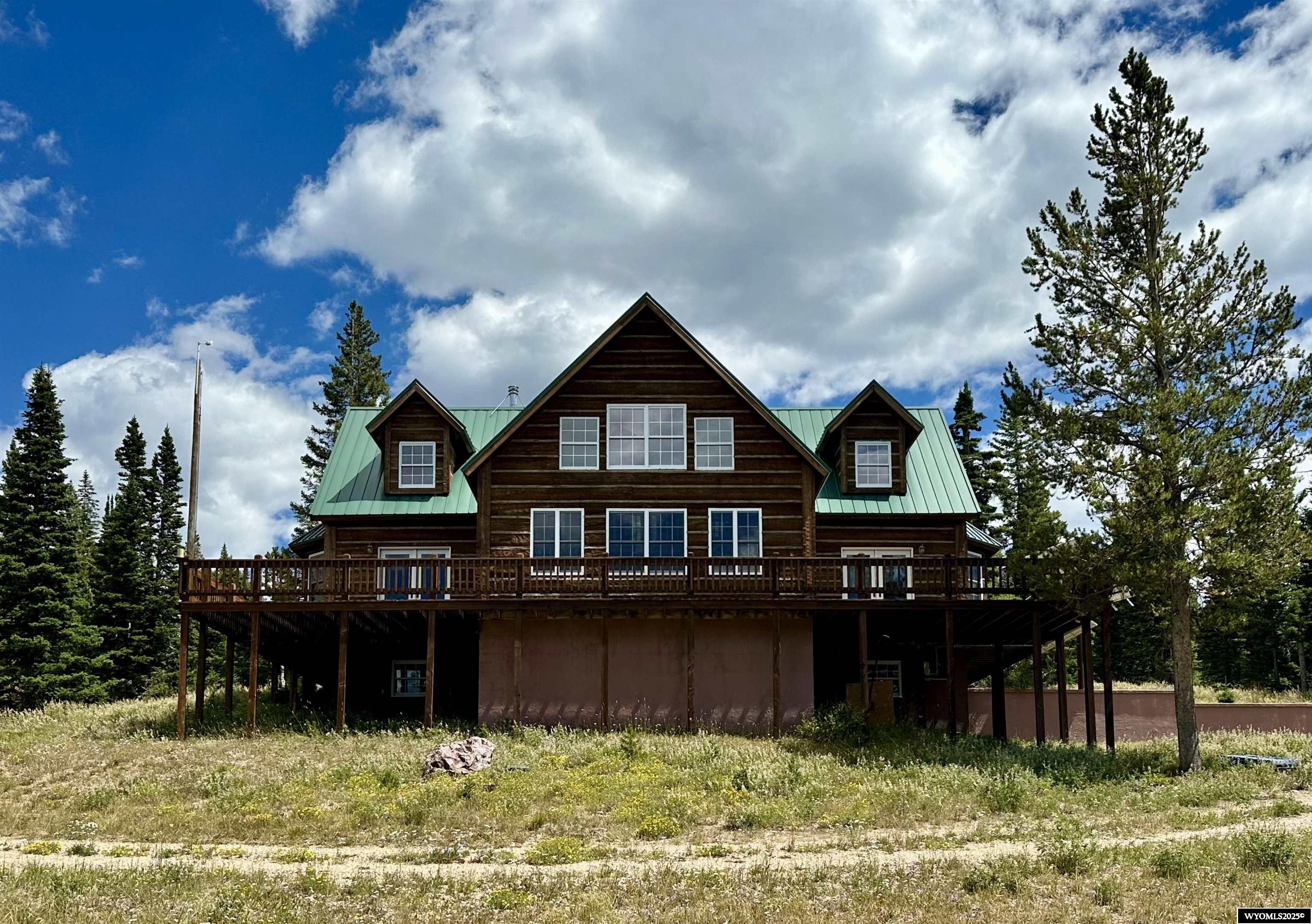 The Lodge at Battle Pass is a labor of love and a dream come true! An outdoor adventure lover's haven in the Sierra Madre Mountains. Enjoy the majestic mountain views & watch the elk pass through from the wrap around deck. Built to last for many generations & withstand mountain climate. Three story concrete walls encased in foam, wrapped & wood sided for excellent energy efficiency. Designed for easy off-grid living with solar panels, generator, new battery bank, 2 propane tanks and so much more! The four lode claims are a combined 43.24 acres with a natural spring on the Hawkeye and Jayhawk claims. Buyer must agree to allow continued access to the spring by the neighbor on the adjacent Anaconda claim. Enjoy top of the world views! The property is only 5 miles from the snowmobile parking area for winter access. Contact Provident Realty for full details on this amazing property!