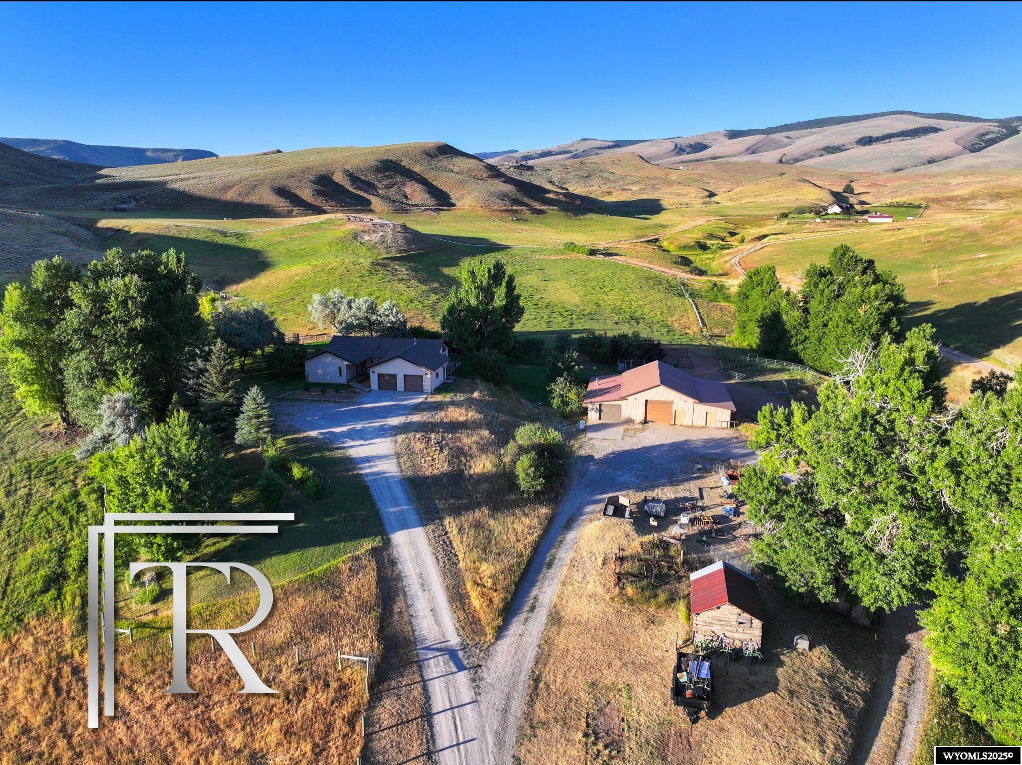 Tucked away in the gentle foothills outside Lander, where the mountains rise in the distance and silence speaks volumes, this 38-acre private haven offers a rare blend of solitude, history, and natural grace. Alongside the deeded acreage, enjoy an 80-acre BLM lease, giving you even more room to roam under endless Wyoming skies.  The heart of the property is a warm, artfully crafted 3,480 sq ft home with 3 bedrooms and 3 baths. Cathedral ceilings and exposed, hand-hewn timber beams welcome you with timeless character, while a bank of southern-facing windows in the walkout basement fills the home with golden light and sweeping views of the surrounding wilderness.  Water is plentiful with both a private well and shared artesian well, and a spacious shop offers flexibility for projects, hobbies, or homesteading life. As a nod to the land’s rich past, the original homestead cabin still stands—weathered, poetic, and full of stories—ready to be restored, repurposed, or simply cherished.  Here, the land feels alive. Wildlife moves freely. The seasons speak clearly. And there’s a peace that can only be found in places untouched by time.  Whether you’re dreaming of a quiet refuge, a working homestead, or a family legacy property, this Wyoming sanctuary is a place to slow down, stretch out, and truly live.