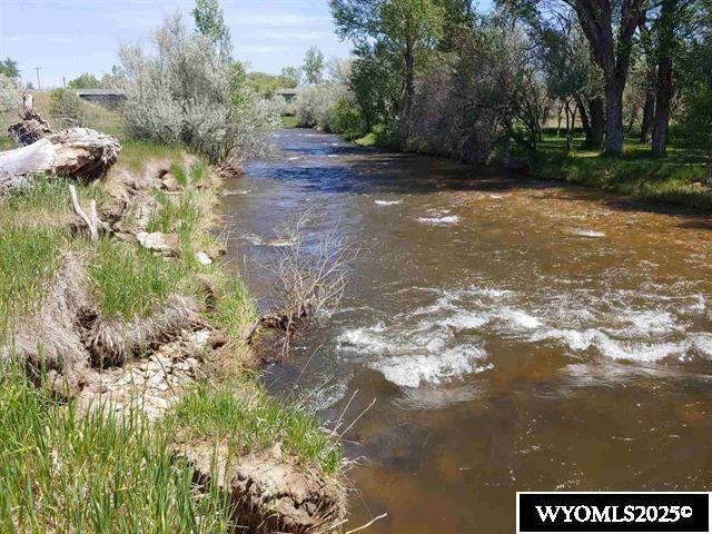RARE FIND 36 acre parcel adjacent to the city limits offers mountain views, a beautiful meadow, creek frontage runs the entire length of the East edge of the property. Visible from I-90, this property is perfect for whatever you can imagine, commercial use, building site, residential development, mobile home park, gentleman's ranch.  There are no covenants, Electricity, city sewer & 2 wells in property. Includes 3 - 2 bedroom homes (850 Sq Ft +/-). Includes 3 - 1 room cabins with no bath. Pier foundations in for 3 more 2 bedroom houses. Nothing like it on the market at this time! Call Kitty Merrill at 307-620-0644 for more information.