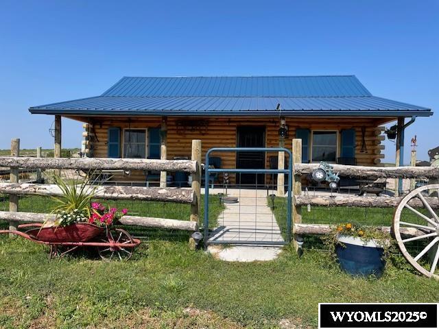 An outstanding quarter section capable of growing any valley crops and also pasturing a small herd of cattle year round.  The log cabin is modern with total electric services. Central AC was added in 2025. There is a windmill with a standby hydrant for stand by water. There are four pastures for grazing rotation fenced with 5 wire and wooden posts.  A 50 x 50 metal machine shed, a three stall horse barn and detached storage shed that could easily converted to a guest home, building another bedroom could be easily added to the home.  A lockable tack shed adjoined the horse barn. The home sets atop a hill and provides an excellent view of the valley.  This is a very well kept property deserving your attention if you are looking for a nice farm.