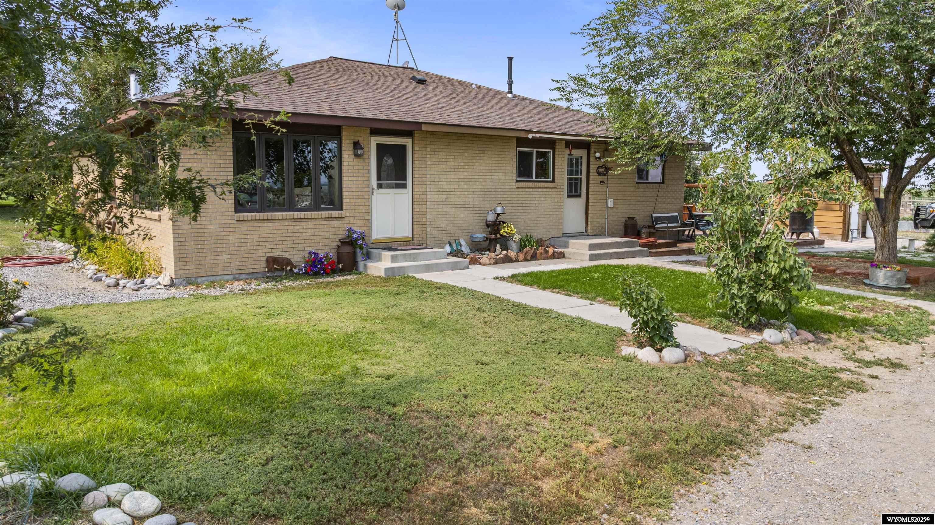 This classic 1958 brick ranch-style home offers 1,665 sq ft of comfortable living on a beautiful 125-acre property. The home is framed by mature landscaping, a lush garden area, and stunning Wyoming views.  A 1,200 sq ft shop plus a 720 sq ft attached shop house provide endless opportunities for work or storage plus guest quarters.  The land is highly productive with 114 irrigated acres under Midvale water rights, currently in an alfalfa/grass mix—perfect for ranching, hay production, or expanding your agricultural dreams. But the land is only part of the draw. Surrounding recreation elevates the lifestyle: Pilot Butte Reservoir & Dam – Close by in Fremont County, this offers boating, fishing (crappie, trout, etc.), camping, hiking, and hunting.   Ocean Lake – Just minutes from the property, Ocean Lake is known for its outstanding fishing (walleye, perch, trout, bass), boating, bird watching, and ice fishing in the winter. It’s a year-round recreational gem and one of Fremont County’s most loved lakes.   Boysen State Park – About 1–1½ hours away, with lake access for water sports, fishing, scenic campgrounds, and trails.   Sinks Canyon State Park – A bit further, with dramatic rock formations, hiking, fishing, picnic spots, and views you won’t forget.   Public lands and dispersed camping – Forest Service lands around the area offer remote camping, hiking, wildlife viewing, and stars-at-night solitude.   Local Lifestyle & Community The property sits near Kinnear, WY, with the larger hubs of Riverton and Pavillion just minutes away. These communities offer schools, dining, shopping, and healthcare, while still preserving the quiet pace of rural life. Riverton, in particular, is becoming a regional hub for growth, with new businesses, expanding services, and a strong sense of community investment.  Riverton is home to Central Wyoming College, a regional medical center, and the Riverton Regional Airport with flights connecting to larger destinations. Its small-town charm is balanced by a growing economy that supports ranching, energy, and outdoor recreation.   Pavillion, just a few miles north, is known for its welcoming agricultural community and annual events that celebrate the area’s ranching heritage.   Nearby Attractions & Benefits Wind River Mountains – A short drive west, this world-class range offers backpacking, climbing, fishing, and hunting. It’s a destination for outdoor enthusiasts seeking pristine wilderness.   Local Events – Fremont County Fair, Riverton Rendezvous Balloon Rally, and small-town rodeos keep the community vibrant year-round.   Access to Yellowstone & Grand Teton National Parks – A few hours’ drive places you at the gateway to two of America’s most iconic national parks, making this property a perfect basecamp for adventure.   Growth & Opportunity The surrounding Fremont County region is experiencing steady growth, driven by agriculture, energy development, and recreation tourism. With increasing interest in Wyoming’s wide-open spaces, properties with reliable water rights and irrigated ground are especially valuable. Owning here means enjoying the peace of country living while also being positioned for the long-term appreciation of productive, well-watered land.  Peaceful, private, and practical, this Kinnear ranch combines country living with excellent water, land, and space to thrive—just a short drive to Riverton, Pavillion, Ocean Lake, and the limitless recreation of central Wyoming.